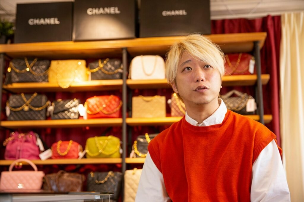 Lovintage founder Chi Kin surrounded by vintage CHANEL handbags